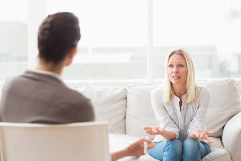 Depressed woman speaking to a therapist
